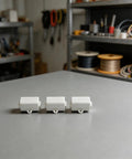 Heavy Duty T Shape Terminal Block Quick Wire Connector 1000V 100A Cable Splitter pack of 3 on gray table in workshop.