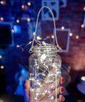 Glass jar with fairy lights held by hand, featuring 5 Pcs Metal Jar Handles And Wire Hangers For Mason Jars With Universal Hemp Rope