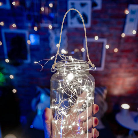 Glass jar with fairy lights held by hand, featuring 5 Pcs Metal Jar Handles And Wire Hangers For Mason Jars With Universal Hemp Rope