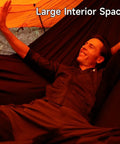 Man relaxing inside UltraLight 11 Ft Hammock Shelter With Net And Rain Fly Tarp Four In One Camping Tent, showing spacious interior