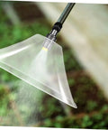 Drift Guard Spray Nozzle With Windproof Shield for Backpack Sprayers misting in garden, enhances coverage and spray efficiency.