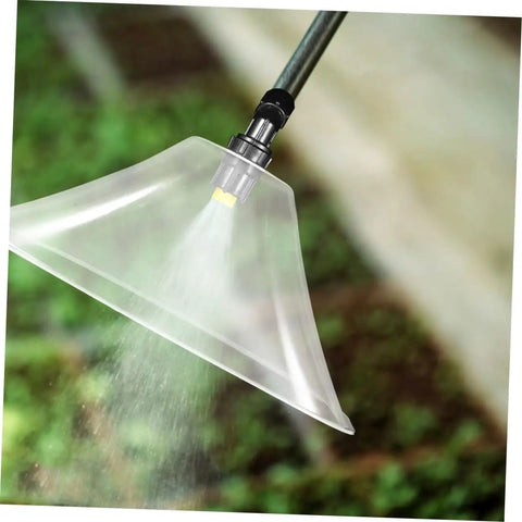Drift Guard Spray Nozzle With Windproof Shield for Backpack Sprayers misting in garden, enhances coverage and spray efficiency.