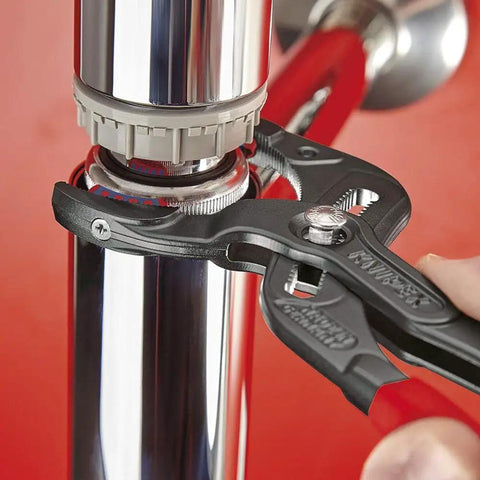 11 250 SBA 10 Inch Pipe And Connector Pliers With Soft Jaws gripping a smooth pipe, replaceable plastic jaws visible.