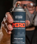 Industrial-Grade High Solids Spray Paint In Safety Yellow, 16 Oz Aerosol Can, Heavy-Duty Protective Coating For Metal, Wood, Equipment, Tools And Maintenance, Long-Lasting Coverage, 6-Pack; hand holding can