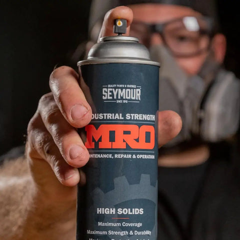 Industrial-Grade High Solids Spray Paint In Safety Yellow, 16 Oz Aerosol Can, Heavy-Duty Protective Coating For Metal, Wood, Equipment, Tools And Maintenance, Long-Lasting Coverage, 6-Pack; hand holding can
