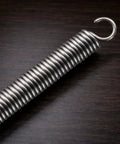 OTF Knife Spring Replacement Kit 12 Steel 304 Springs For Ultratech UT Series Knives on a wooden surface