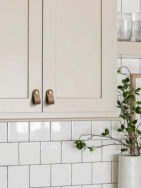 Brown Leather Drawer Pulls 6 Pack For Kitchen Cabinets And Drawers installed on cream cabinet doors in a modern kitchen