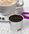 Stainless Steel Reusable K Cup 2 Pack With Built In Metal Filter for Keurig placed on counter with coffee and purple lid