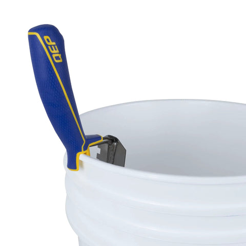 Comfort Grip Square-Notch Margin Tile Trowel With Six-Inch By Two-Inch Blade attached to a bucket hook