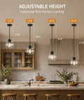 Straight Up Matte Black Globe Pendant Lights 2 Pack With Clear Glass Shades adjustable height options in kitchen setting.