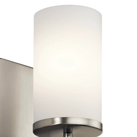 Close-up of Crosby 9.25 Inch Wall Sconce In Brushed Nickel with Satin Etched Cased Opal Glass showcasing top detail.