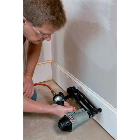16-Gauge Straight Finish Nailer Kit With Tool-Free Depth-Of-Drive Adjustment being used for trim installation on wall