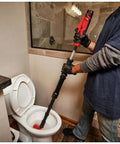 User operating Badass 12V M12 Ready Drain Snake And Toilet Auger Combo Kit on a toilet for effective clog removal.