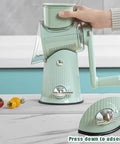 Side view of mint green 5-in-1 hand-crank kitchen grater and slicer with hopper attachment.