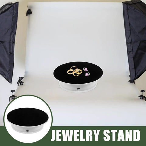 Spinning 360 Electric Turntable With Adjustable Dual Speeds For Jewelry Watch Showcase And Photography Shots Using Sleek Plastic Base displaying rings on black velvet top.