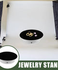 Cool Electric Rotating Display Stand With Adjustable Motorized Turntable featuring rings on a black velvet top, ideal for photo shoots.