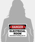 Hella Tough Aluminum Electrical Room Sign For Indoor And Outdoor Areas Killer Rust Proof Coating Zero Fuss Wall Mount Held by a person.