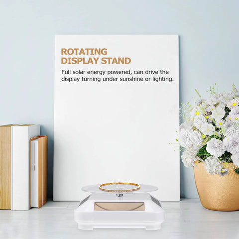 Ipetboom Battery Free Rotating Display Stand Electric Jewelry Showcase Solar Powered Turntable showcasing a gold ring on a white base.