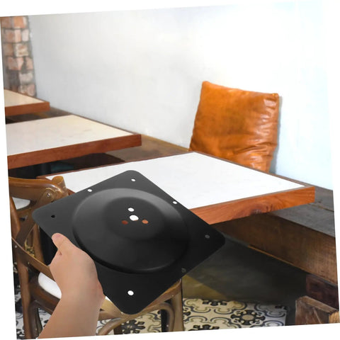 Hella Sturdy Heavy Duty Iron Table Leg Connector Bracket and Furniture Fastener for DIY repairs held in hand, matte black finish.