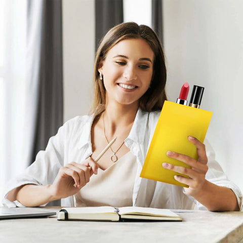 Woman holding a yellow padded envelope with self-sealing lip, containing lipstick, showcasing Bubble Mailers 3.5x5 Inch 50 Pack Self Sealing Waterproof Cushioned Envelopes Yellow Padded Mail Bags For Shipping Pro Grade Heavy Duty Tear Resistant Protection And Secure Quick Seal