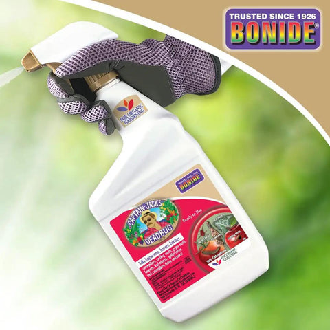Gloved hand holding Captain Jack's Deadbug Brew Ready To Use Spray For Outdoor Insect And Mite Control In Organic Gardening 32 Oz