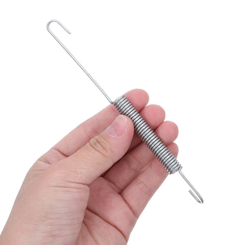 Person holding a metallic high elasticity tension spring set for generator throttle rod, governor spring kit.
