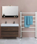 Bathroom with wall-mounted 6-bar towel warmer, blue towel, vanity mirror, and sink. Towel Warmer for Bathroom with Timer and Wall Mounted Plug In Design, 6 Bar Heated Towel Rack, Fast Drying Spa Style Towel Dryer for Cozy Mornings and Preventing Dampness.