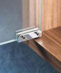 Satin Black Glass Door Pivot Hinge Pair for free swinging glass doors installed on a frameless glass and wood setup.