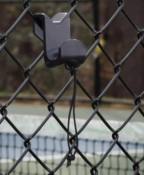 Chain Link Fence Hook For Sports Bags With Paracord Lanyard Heavy Duty Fence Hanger installed on a chain-link fence at a court