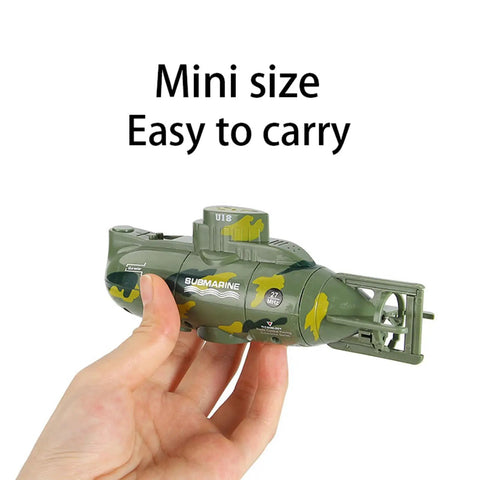 Hand holding Rad Six Channel RC Submarine Toy For Kids Waterproof With Diving And Surfacing Action Realistic Ocean Play in green color