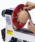 Hands using Emery Cloth Roll Set Six Grits 80 150 240 320 400 600 Pro Grade Heavy Duty for woodworking on a wooden piece on lathe