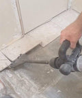 Person using SDS Max Floor Scraper Heavy Duty Beast Pro Tool With Two Point Five Millimeter Blade for fast concrete demo and floor prep.