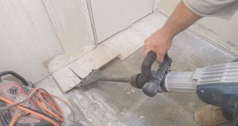 Person using SDS Max Floor Scraper Heavy Duty Beast Pro Tool With Two Point Five Millimeter Blade for fast concrete demo and floor prep.