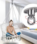 Person sitting in a swing chair supported by Silent Ball Bearing Swing Hangers, Heavy Duty 360 Degree Rotating Swing Swivel Hooks, indoor setting.