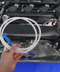 Must Have Brake Bleeder Hose Kit For Cars And Bikes, 5 16 Inch High Temp Silicone Tubing in hand above engine