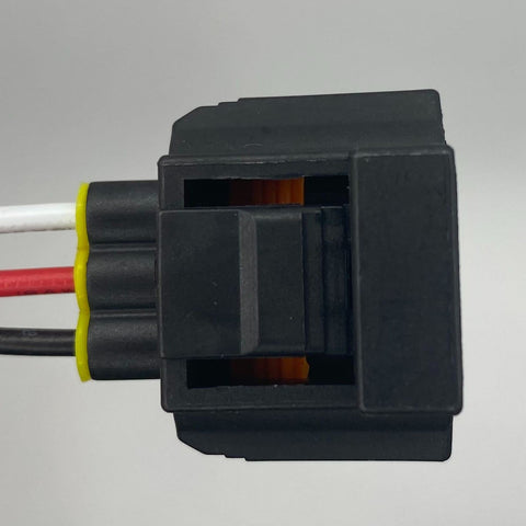 Side view of 3-pin black brake fluid level sensor connector with red, white, and black wires and yellow seal