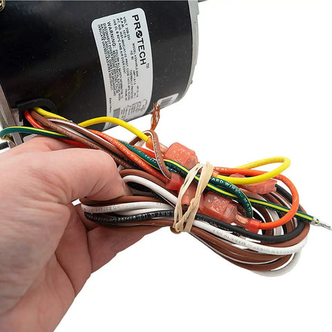 Close-up of HVAC Condenser Motor 1/6-1/3 HP, Single Phase, 1 Speed, 208/230V, 1075 RPM wiring with hand holding cables