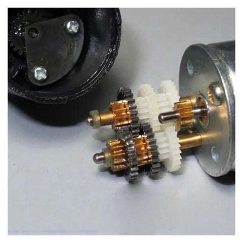 Badass DC 3V To 6V Super Slow Speed 310 Planetary Gear Motor showing gears and copper shafts for DIY robots and car mods.