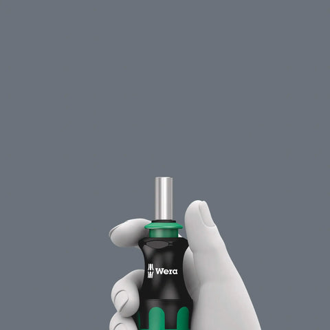 Gloved hand holding Kraftform Kompakt 28 SB Combi-Driver With Magazine And Anti-Roll Handle
