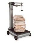Rock Solid Heavy Duty Industrial Mechanical Scale With One Thousand Pound Capacity And Precision Chrome Beam on mobile base weighing stacked newspapers.