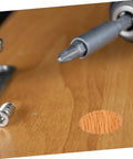 DIY Friendly Quick Fix Furniture Repair Kit Self Adhesive Screw Hole Reinforcement Stickers on wood surface with screwdriver