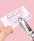 Top Shelf Blank Reward Cards With Zero Hassle Metal Heart Puncher With 100 Pack Hella Thick Coated Cardstock For DIY Crafting Small Biz Loyalty Rewards And Gift Tag Creations, hand holding punch card with heart puncher.