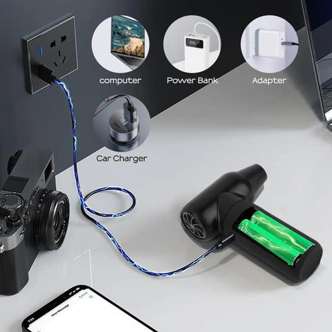 Cordless Electric Air Duster With 3 Gear Mini Portable Jet Dry Blower charging setup shown with camera and phone nearby