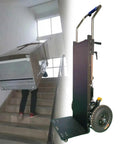 A person using a Heavy Duty Electric Stair Climbing Hand Truck Cart With 400 Kg Capacity to move furniture up stairs.