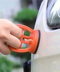 Multi Spec Suction Cup Handle Dual Function Lifter And Dent Puller in use, pulling dent from a car with strong grip.
