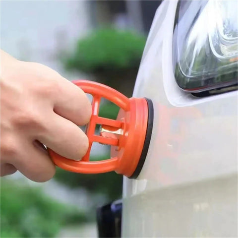 Multi Spec Suction Cup Handle Dual Function Lifter And Dent Puller in use, pulling dent from a car with strong grip.