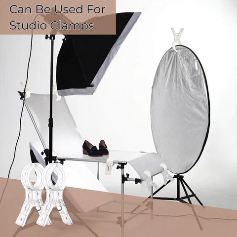 Ultimate Balloon Arch Kit With 10 Clear Spring Clips and 50 Transparent Long Bands used as studio clamps on light reflector