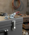 Heavy Duty Spring Loaded Toggle Latch on a toolbox lid, stainless steel, designed for vibration free locking action in a garage.