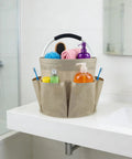17L Foldable Cleaning Caddy with handle and six pockets holding toiletries on bathroom sink.