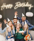 Family party with "Happy Birthday" neon LED sign backdrop, part of the Two Pack Birthday Neon LED Sign Set with Dual Display Options.